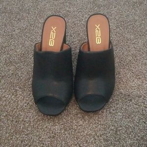 Black and brown leather mules